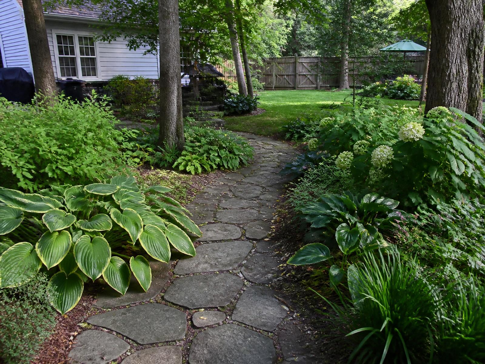 Finished Zionsville backyard garden path with mature shade plantings and lawn